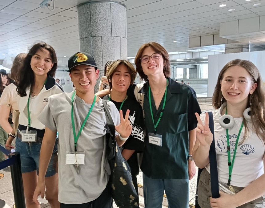 Students smiling together at the airport